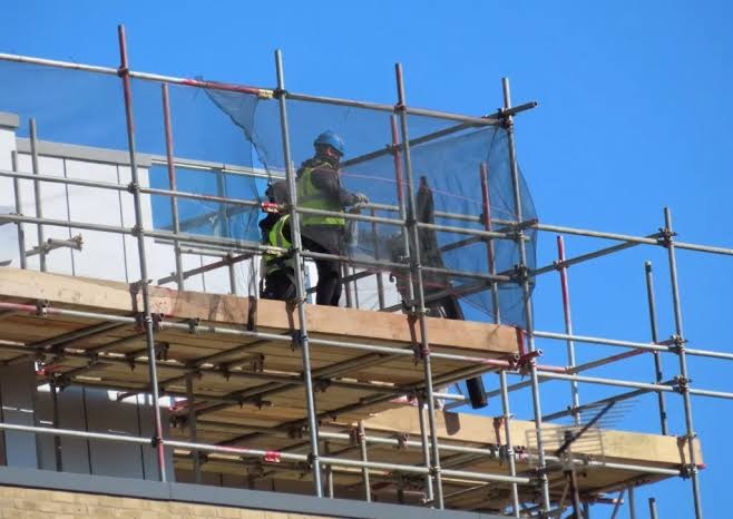 Workers and scaffolding on a project site